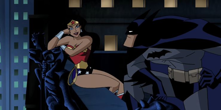 Batman and Wonder Woman flirting on a rooftop.