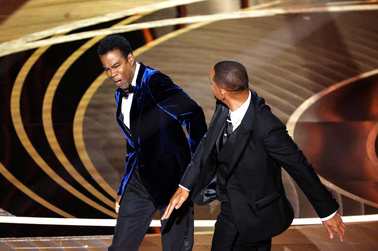 Will Smith slapping Chris Rock for joking about his wife's attire at the Oscars.