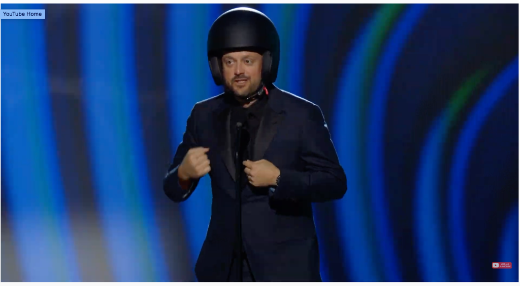 Nate Bargatze pokes fun at the Will Smith-Chris Rock incident by wearing helmet onstage at Grammys.