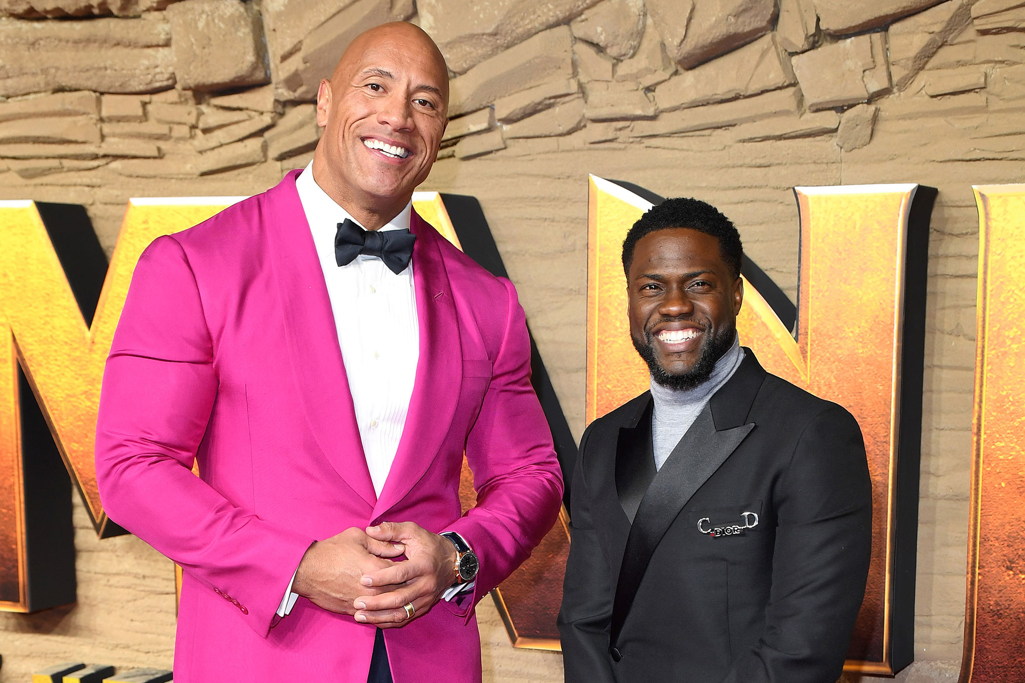 Dwayne "The Rock" Johnson and Kevin Hart posing together.