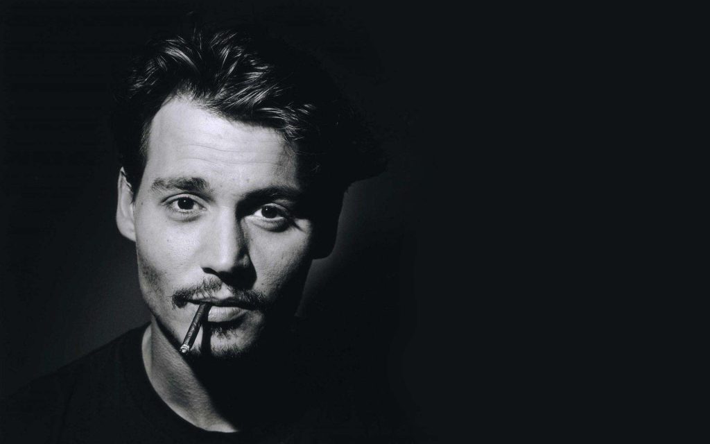 Johnny Depp smoking a cigar for the cameras.