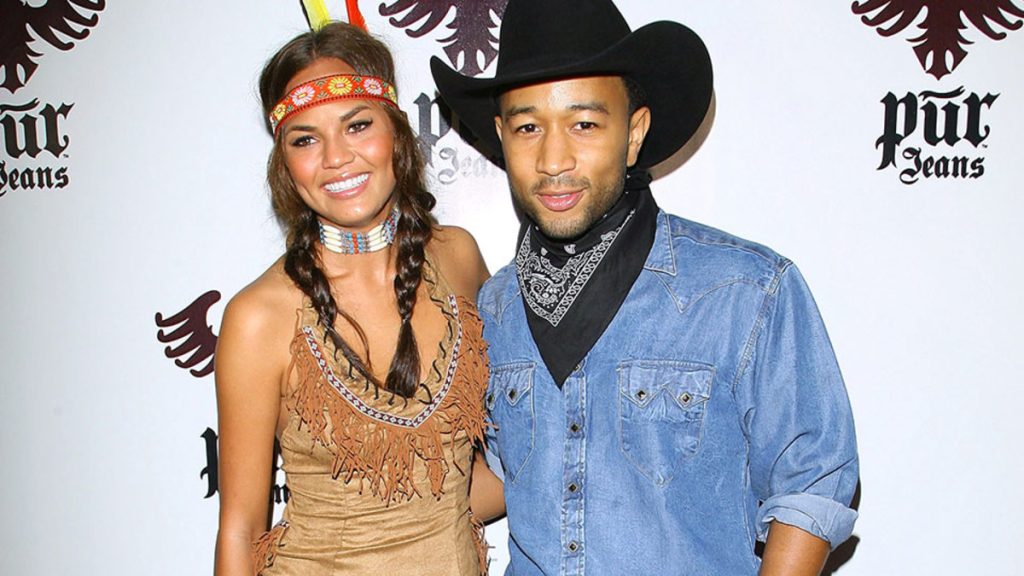 Chrissy Teigen dressed in a Native American get-up with her husband John Legend 
