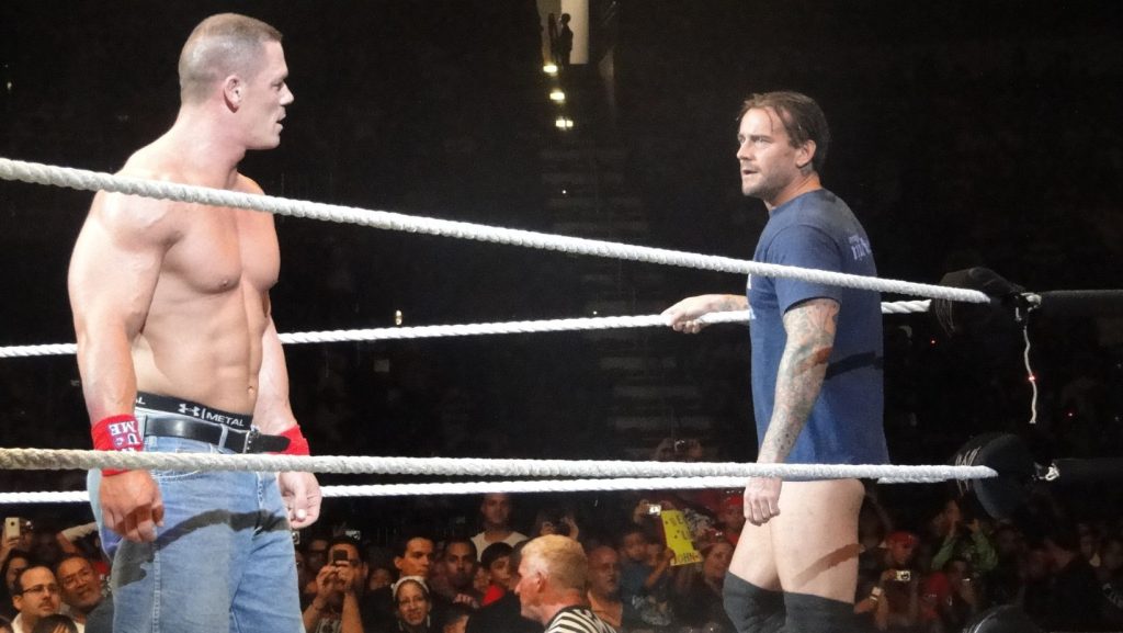 cena and cm punk inside the ring (via wikimedia commons)